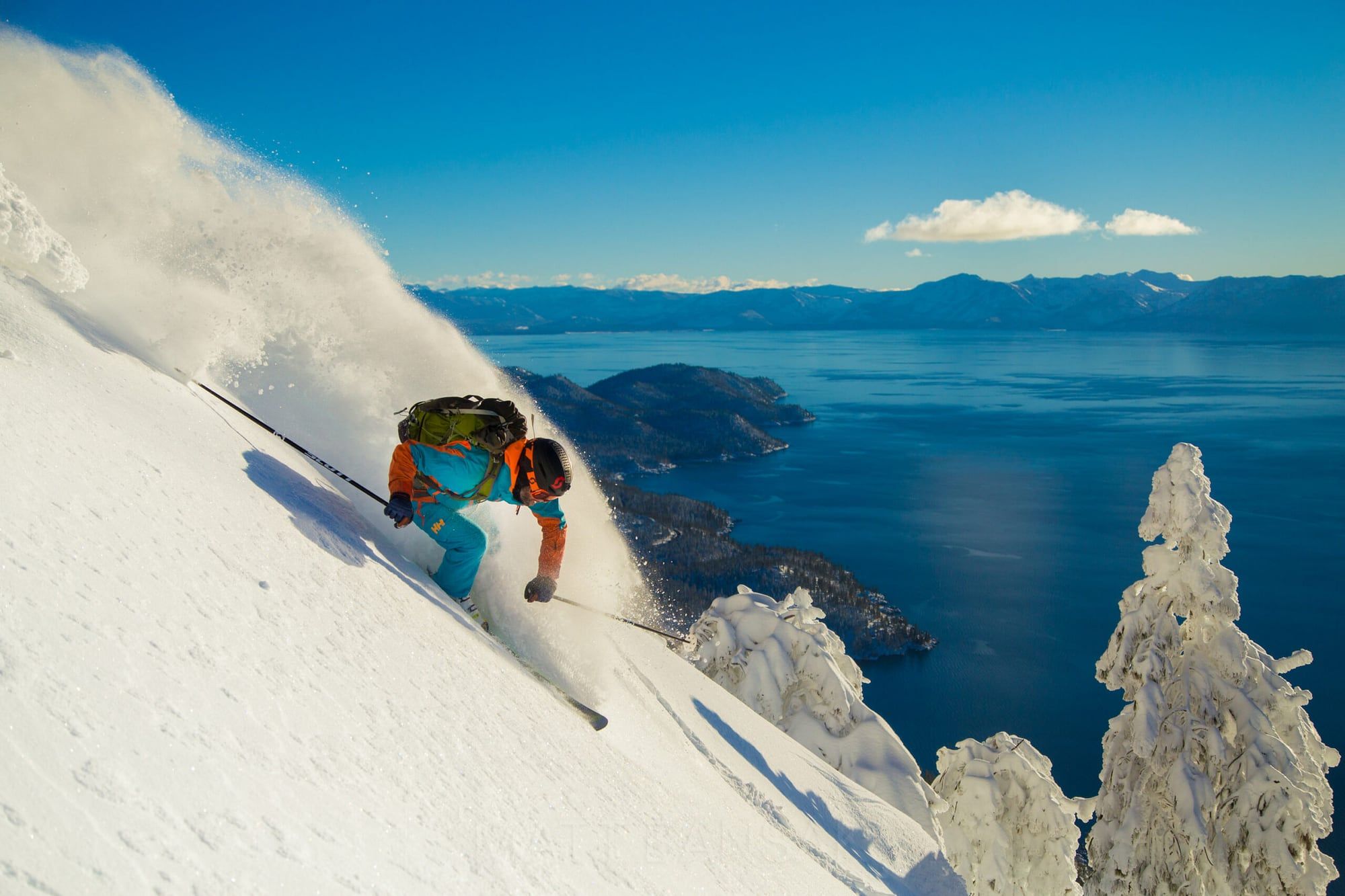 Skier carving powder above Lake Tahoe